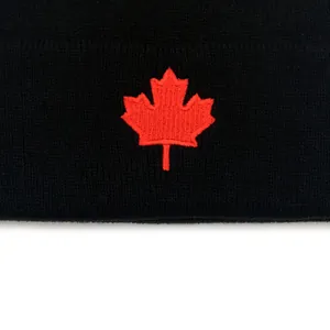 Black knit beanie with red Canadian maple leaf embroidery for winter warmth