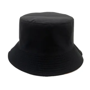 Minimalist black cotton bucket hat with a wide brim and decorative stitching