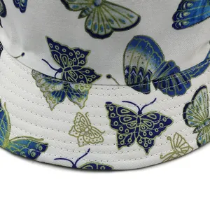 White bucket hat with blue and green butterfly print featuring precision stitching details