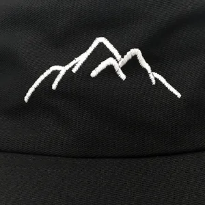 Outdoor bucket hat with white mountain embroidery detail on black twill fabric
