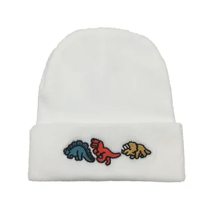 White knitted beanie with colorful dinosaur embroidery for winter warmth and style
