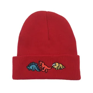 Red knit beanie featuring cute cartoon dinosaur embroidery and a classic cuffed design