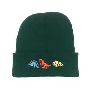 Deep green knit beanie with colorful dinosaur embroidery for winter warmth and style