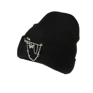 Black knit beanie with punk silver metal chains, butterfly charm, and safety pin detail