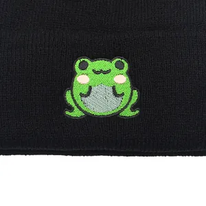 Black knit beanie with cute green frog embroidery, cozy cartoon style winter cap