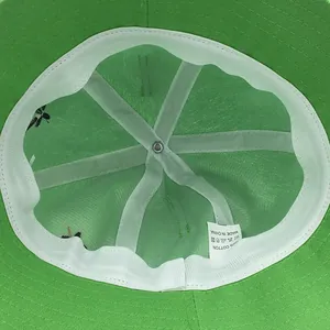 Interior view of green cotton frog sun hat showing sweatband and 100% cotton label