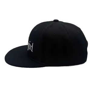 Black flat brim baseball cap with white X-girl embroidery on a clean white background