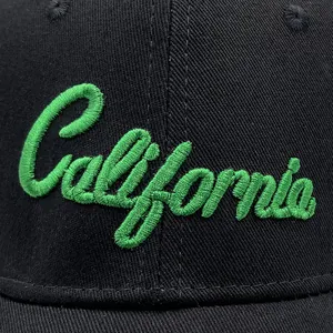 Macro shot of green California embroidery on black canvas baseball cap fabric
