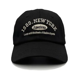 Close-up of white American New York embroidery on black cotton baseball cap