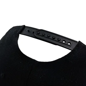 Black snapback baseball cap with devil horn accents and adjustable plastic strap closure