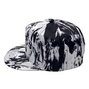 Flat brim baseball cap with black and white graffiti print and X embroidery details