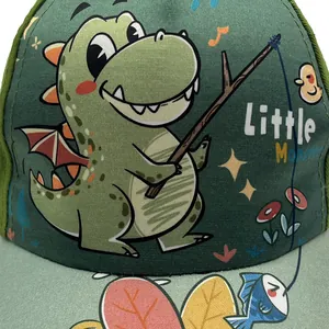 Detail of cartoon dinosaur print and Little Monster text on kids green baseball cap
