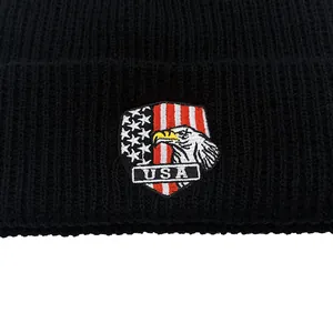 Black knit beanie featuring embroidered USA eagle and American flag shield logo