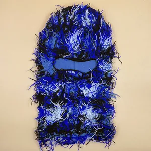 Close-up detail of distressed knit balaclava with blue and black tassel textures