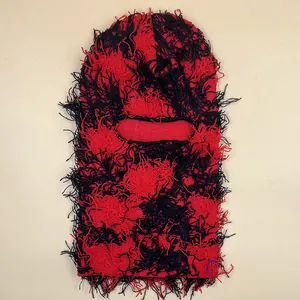 Distressed red and black knitted balaclava mask with punk style fringe details