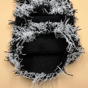 Deconstructed black and white knit balaclava with fringe details for winter fashion
