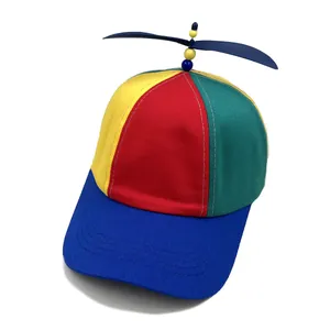 Detail of colorful patchwork propeller hat with rotating top and blue stitched brim
