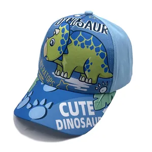 Detail of blue kids baseball cap with green triceratops cartoon and dinosaur patterns