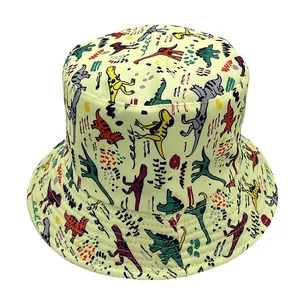 Pale yellow bucket hat with colorful hand-drawn dinosaur prints for summer sun protection