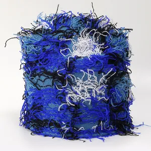 Detailed view of colorful camouflage knit yarn fringe with blue and white textures