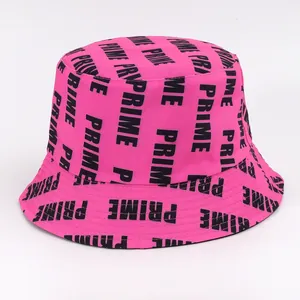 Detail of hot pink bucket hat featuring all-over black PRIME letter print and stitched brim