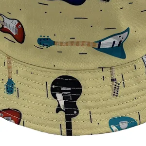 Close-up detail of electric guitar prints and stitching on mustard yellow bucket hat