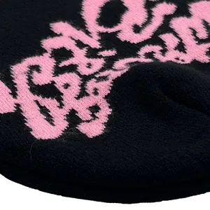 Black knitted Hellstar beanie featuring pink logo detail for winter warmth and fashion