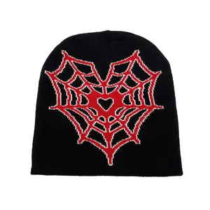 Black knit beanie featuring a striking red heart spider web pattern in a street style