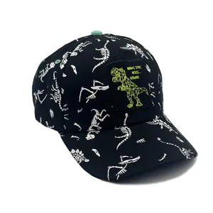 Detail of kids baseball cap with white dinosaur skeleton prints and green T-Rex patch