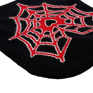 Detailed close-up showing the spider web jacquard texture on this black knit beanie cap