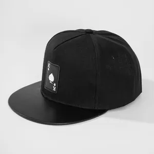 Black flat-brimmed snapback hat with King of Spades embroidery and faux leather brim