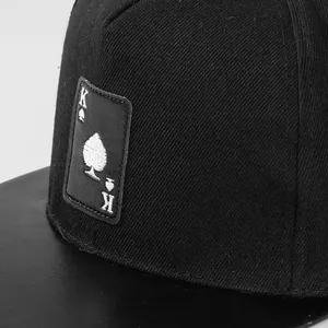 Detailed macro view of King of Spades embroidery on black twill hip hop cap