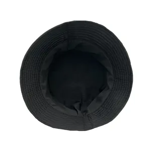 Detail view showing the reinforced stitching and inner lining of the black bucket hat