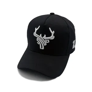 Close-up of white antler embroidery and detailed stitching on a black cotton baseball cap