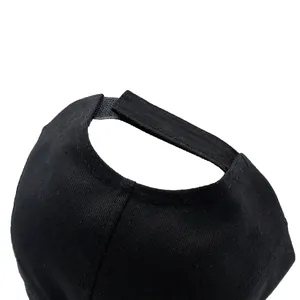 Rear view of black cotton baseball cap showing adjustable hook-and-loop strap closure