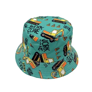 Close-up of light green sun hat featuring yellow excavator and construction patterns