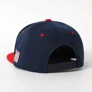 Rear view of a navy USA hip hop snapback cap with a red flat brim and American flag patch