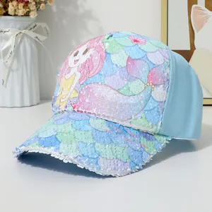 Close-up of sparkling mermaid sequins on a light blue baseball cap for girls