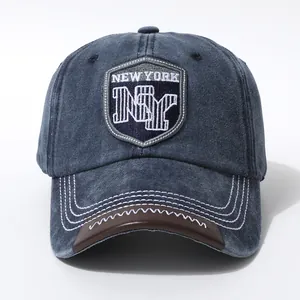 Close-up of vintage navy blue New York baseball cap with embroidery and leather visor edge
