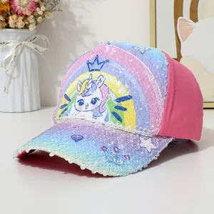 Close-up of colorful sequins with unicorn and rainbow patterns on a pink baseball cap