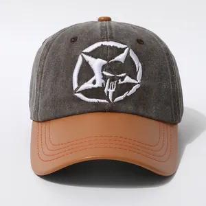 Détail de la casquette vintage en coton gris et cuir marron avec broderie de crâne