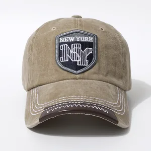 Detail of vintage NYC baseball cap featuring a navy shield patch and leather brim trim