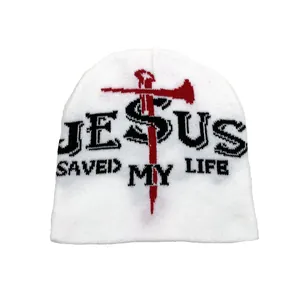 Detail of Jesus Saved My Life jacquard text and cross pattern on white knitted beanie
