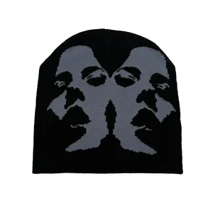 Knitted beanie featuring an abstract face sketch jacquard design in grey and black