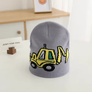 Grey knitted beanie for kids featuring a yellow excavator jacquard pattern for winter warmth