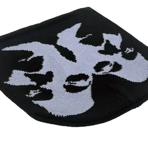 Streetwear knitted beanie featuring abstract sketch face jacquard in black and white