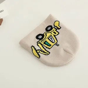 Beige knitted beanie for boys featuring a cute yellow excavator jacquard pattern