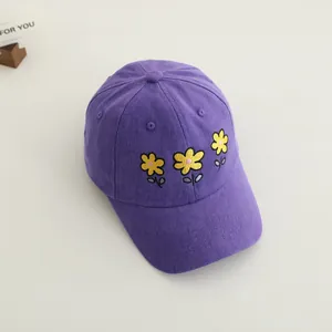 Kids purple cotton baseball cap with yellow floral embroidery on light background
