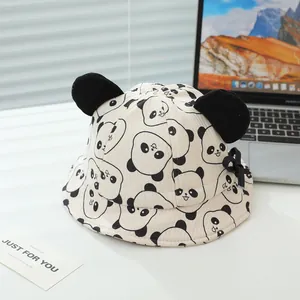 Detail of baby panda sun hat with 3D ears on a minimalist white desk background