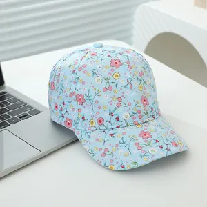 Detail of light blue baseball cap with colorful floral prints and curved brim